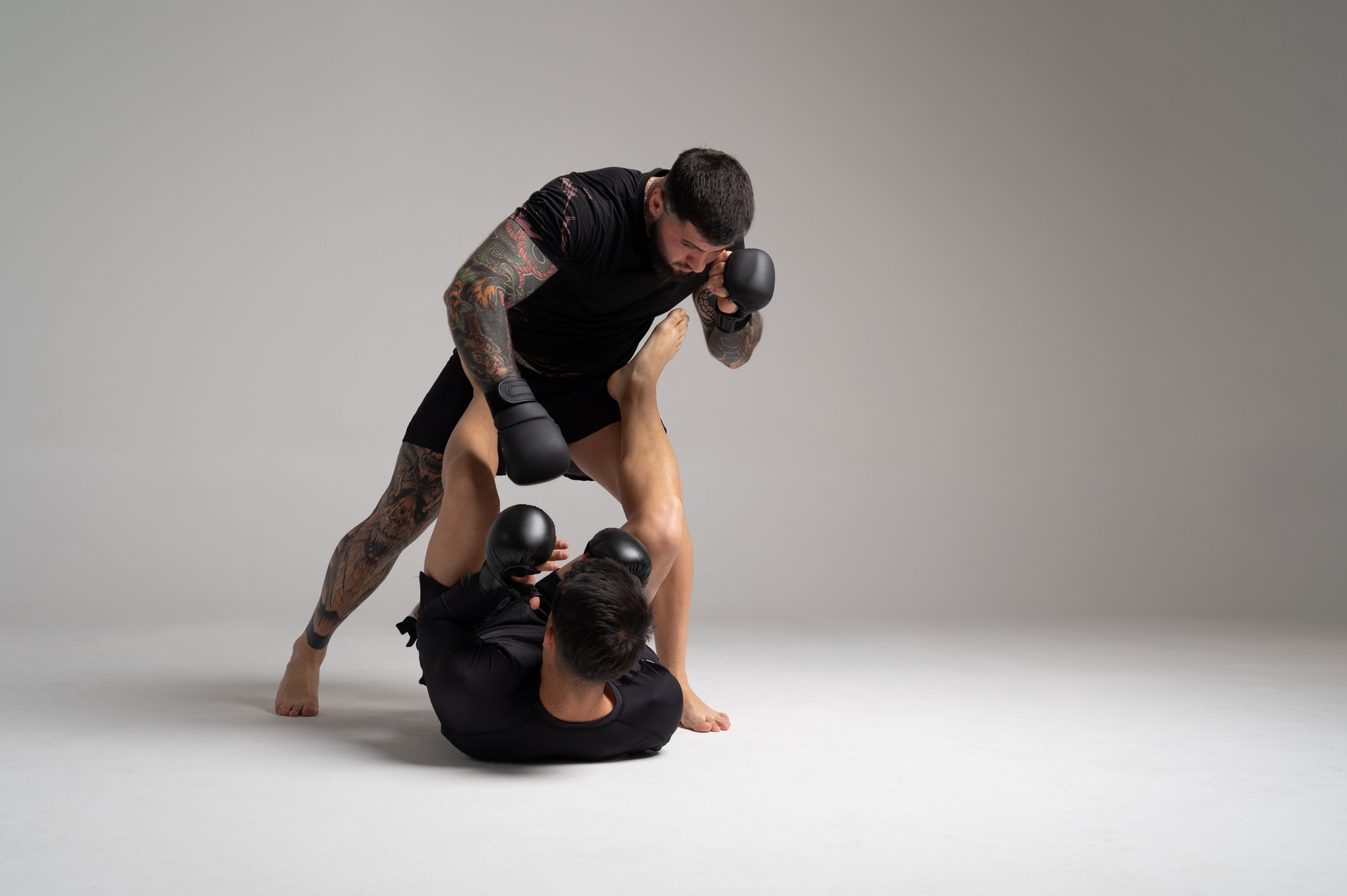 Mma fighters sparring intensely in studio
